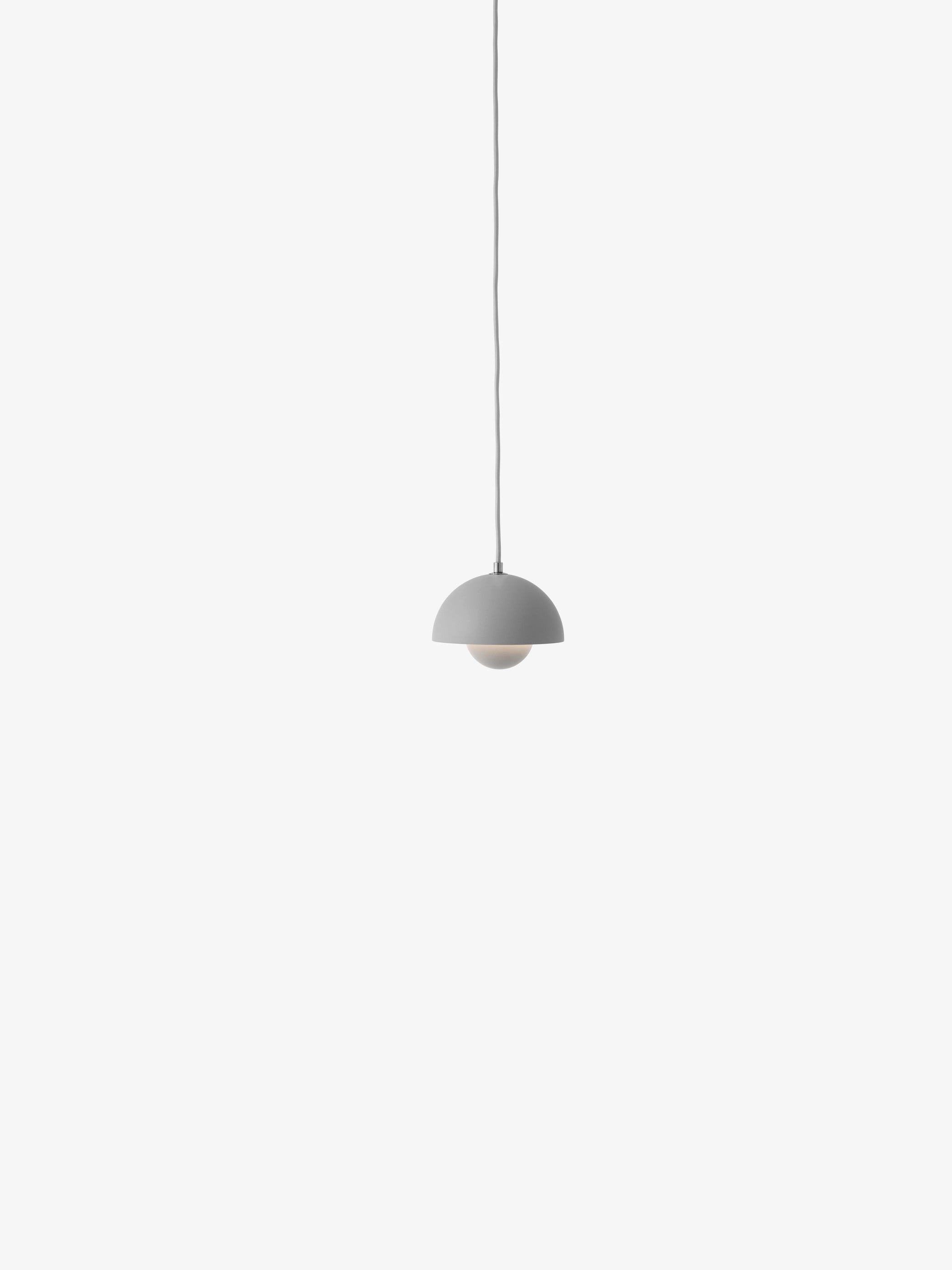A matt grey Flowerpot VP10 pendant lamp hangs from a same-colored cord against a white background, featuring a domed outer shade and a smaller inner shade.