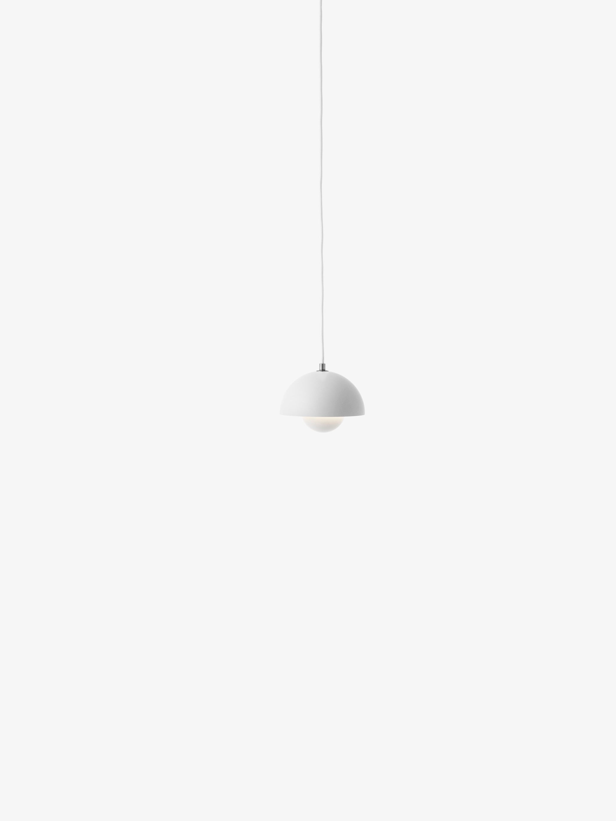 A matte white Flowerpot VP10 pendant lamp hangs from a same-colored cord against a white background, featuring a domed outer shade and a smaller inner shade.