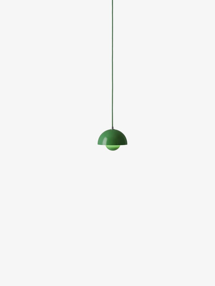 A bright green Flowerpot VP10 pendant lamp hangs from a same-colored cord against a white background, featuring a domed outer shade and a smaller inner shade.