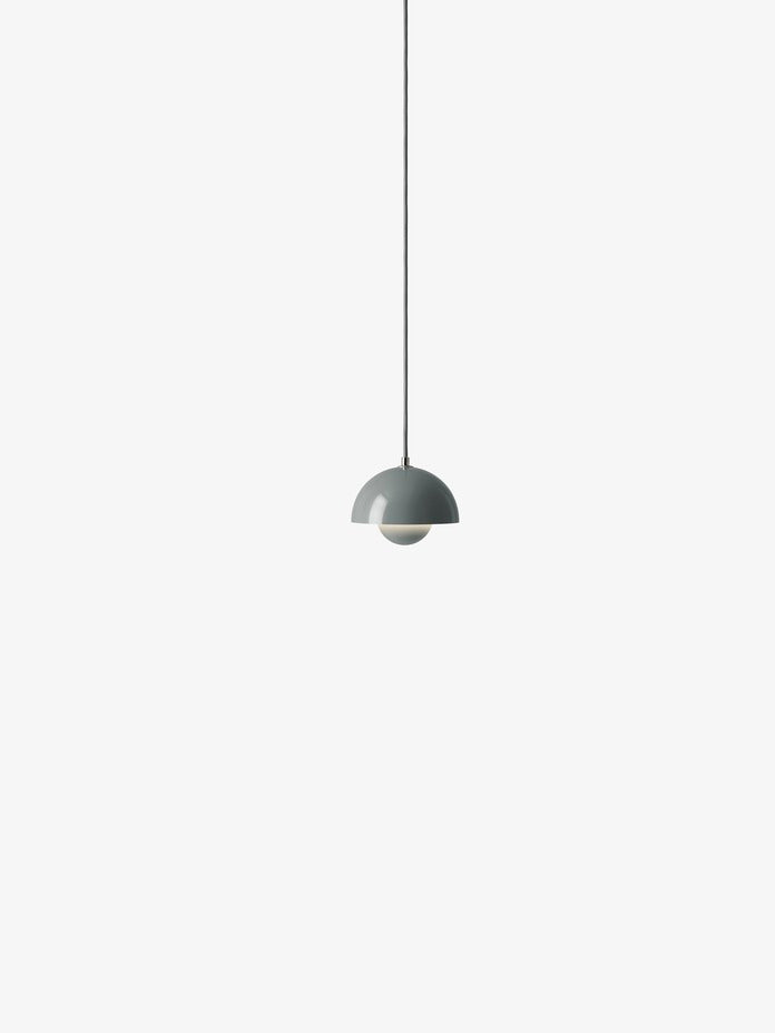 A blue/grey Flowerpot VP10 pendant lamp hangs from a same-colored cord against a white background, featuring a domed outer shade and a smaller inner shade.
