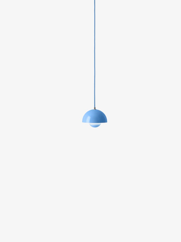 A light, aqua blue, Flowerpot VP10 pendant lamp hangs from a same-colored cord against a white background, featuring a domed outer shade and a smaller inner shade.