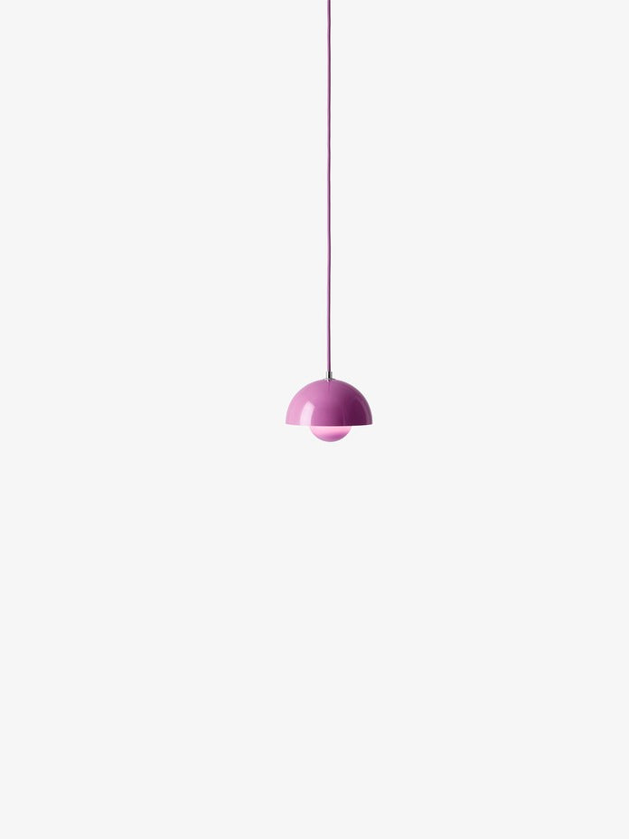 A neon pink Flowerpot VP10 pendant lamp hangs from a same-colored cord against a white background, featuring a domed outer shade and a smaller inner shade.